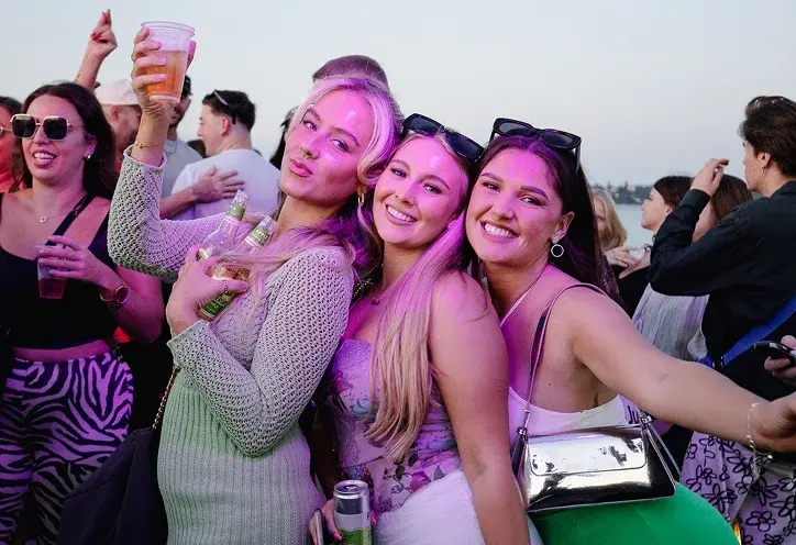 Throwback event at dusk with crowd and red lights