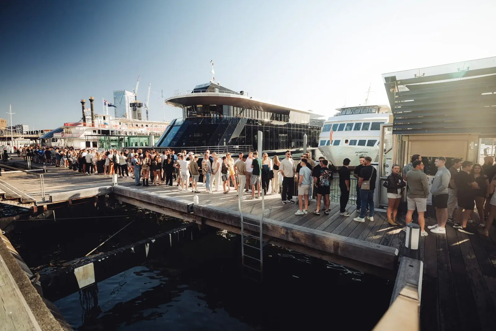 Outdoor DJ set with INCEPTION sign and city skyline